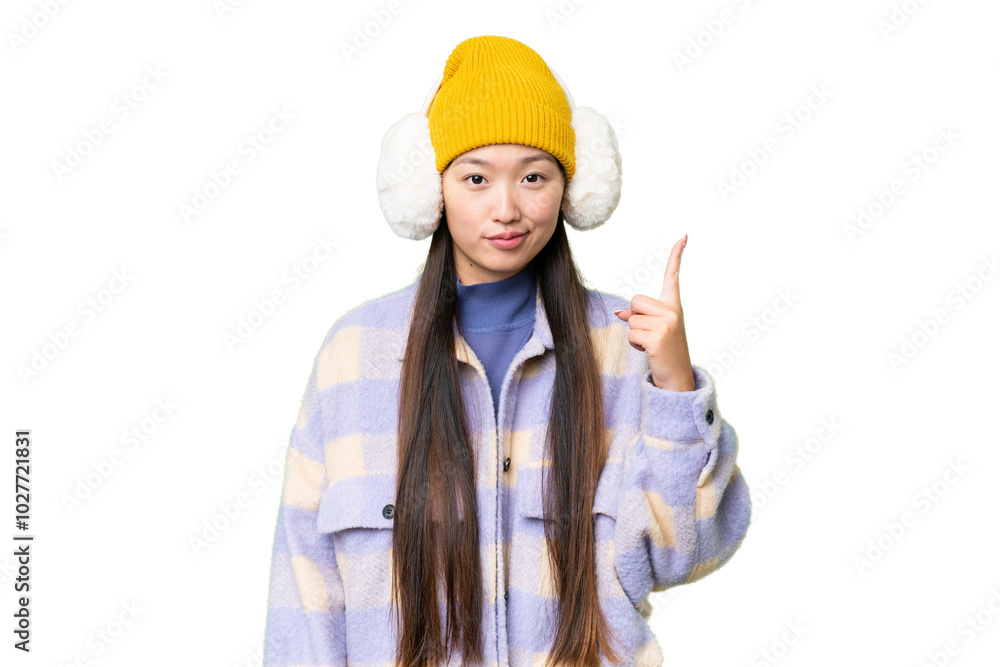 Young Asian woman wearing winter muffs over isolated chroma key background pointing with the index finger a great idea Young Asian woman wearing winter muffs over isolated chroma key background pointing with the index finger a great idea