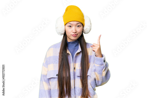 Young Asian woman wearing winter muffs over isolated chroma key background pointing with the index finger a great idea