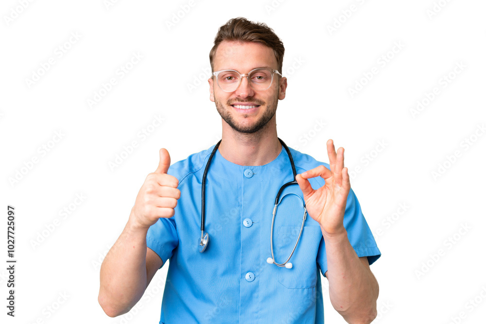 Young nurse man over isolated chroma key background showing ok sign and thumb up gesture