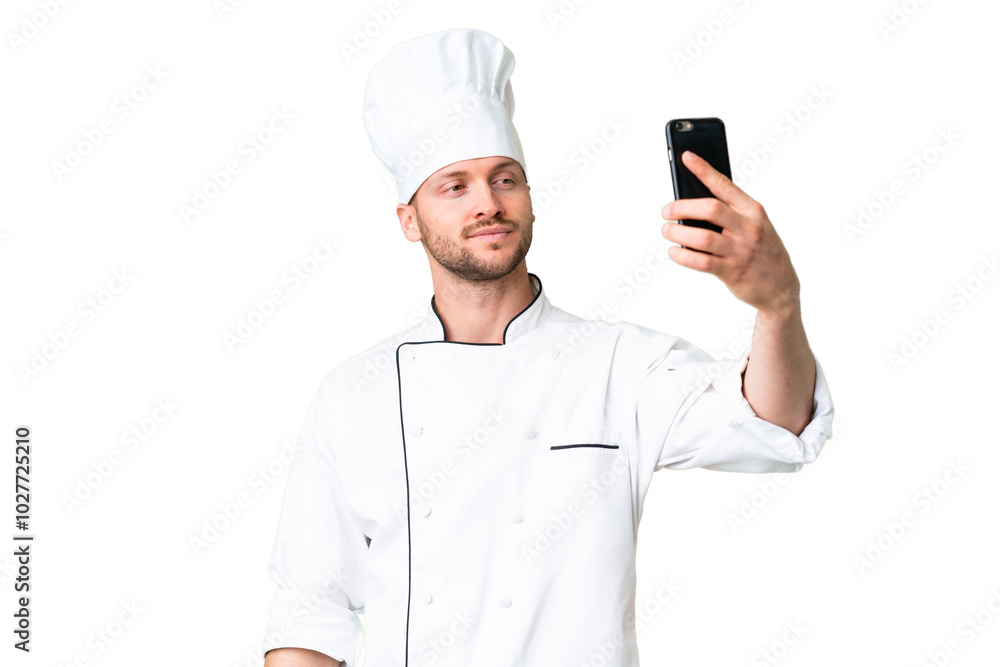 Young caucasian chef over isolated chroma key background making a selfie Young caucasian chef over isolated chroma key background making a selfie