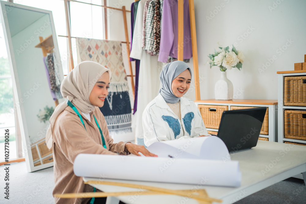 In a vibrant studio, two designers brainstorm while creating sketches and designs In a vibrant studio, two designers brainstorm while creating sketches and designs