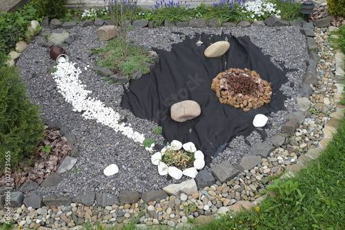 Fotografie Landscape design of the garden with pot, plants and stones at the registration s