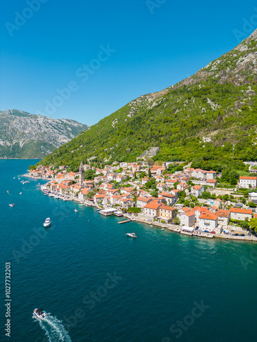 Aerial drone view of Perast city. Situated in Montenegro is a famous travel destination. View of Church of San Nicholas. Panoramic top view of costal city.