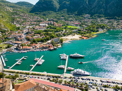 Aerial view of famous travel destination Kotor. Situated in Montenegro. Panoramic view of all region. Luxury cruise ships and yachts. Turquoise water. 
