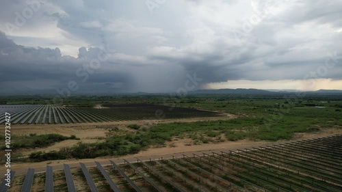 drone shot of Rain aproaching to solar farm project in the caribbean photo