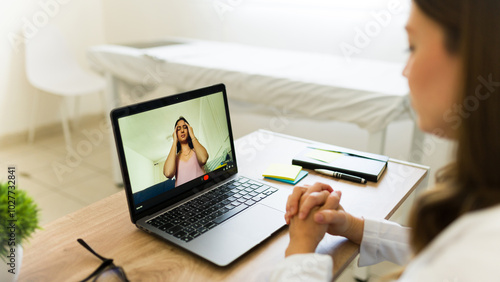 Doctor is having a video call with her patient who is describing her symptoms