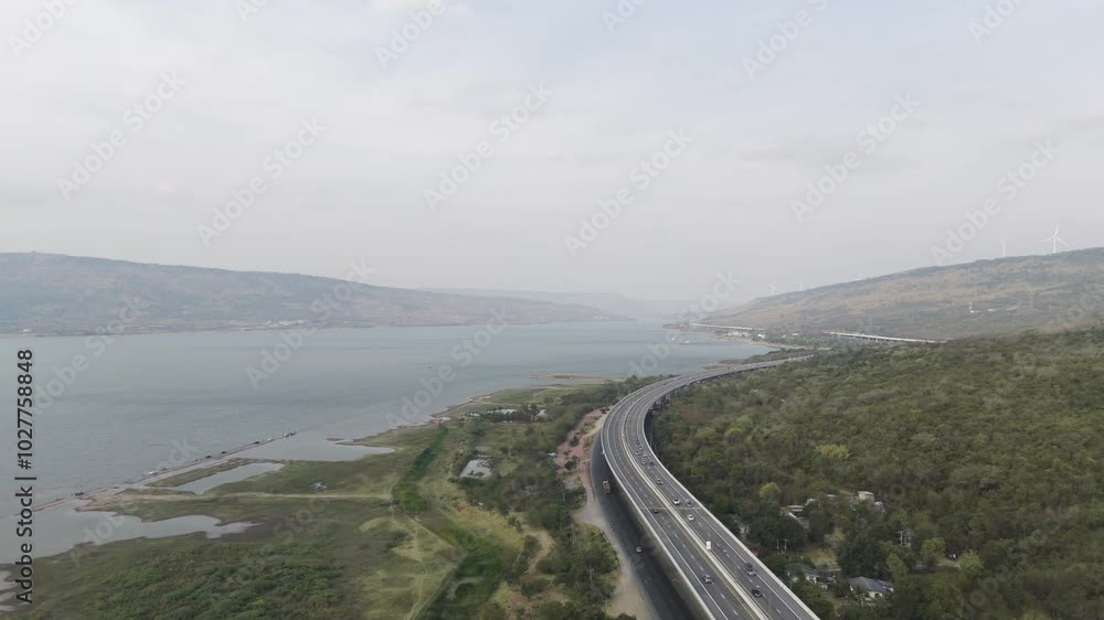 The M6 motorway Expressway Nakhon Ratchasima Province - Bang Pa-in. Lam Ta Khong River and Mountain. Drone shot of scenic landscape rural place traffic. Nakhon Ratchasima Thailand. Motorway Korat The M6 motorway Expressway Nakhon Ratchasima Province - Bang Pa-in. Lam Ta Khong River and Mountain. Drone shot of scenic landscape rural place traffic. Nakhon Ratchasima Thailand. Motorway Korat