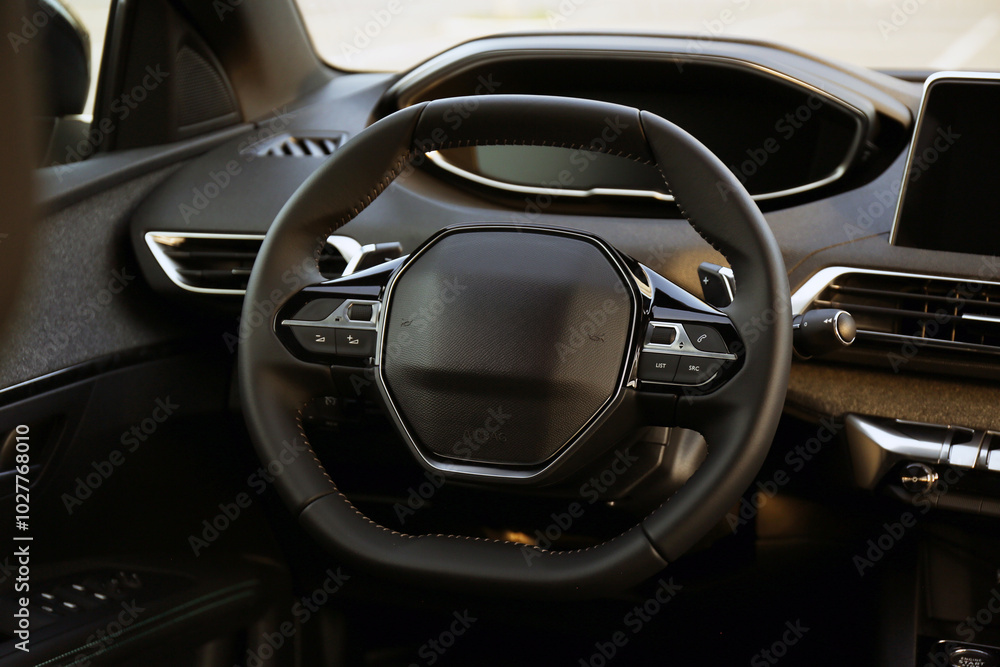Steering wheel and dashboard inside of modern luxury car, closeup Steering wheel and dashboard inside of modern luxury car, closeup