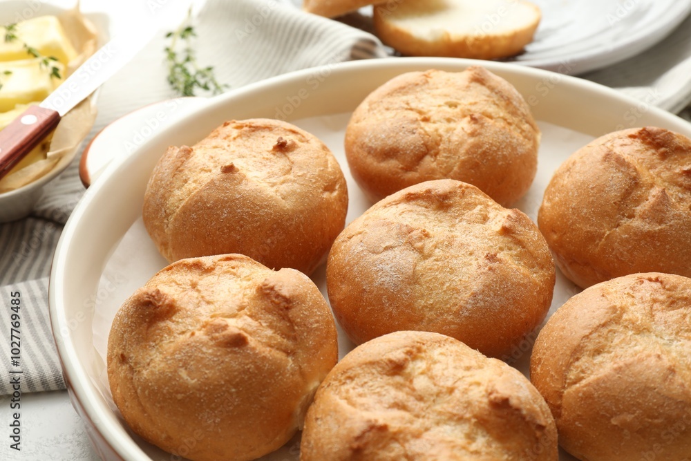 Baking dish with homemade tasty buns on table, closeup Baking dish with homemade tasty buns on table, closeup