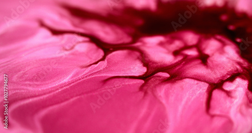 Ink spill. Wet glitter flow. Defocused magenta pink red color shimmering marble texture paint emulsion spreading abstract art background.