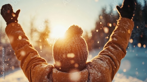 An individual basks in the golden sunlight, arms stretched upwards amid a snowy landscape, radiating a sense of freedom and jubilance under a winter's sky.