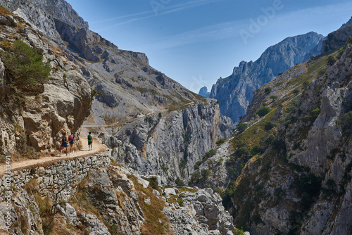 The trail in the cliffs with hikers
