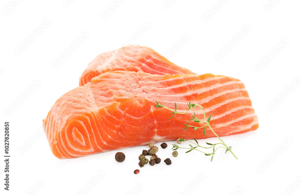 Pieces of fresh salmon, peppercorns and thyme isolated on white Pieces of fresh salmon, peppercorns and thyme isolated on white