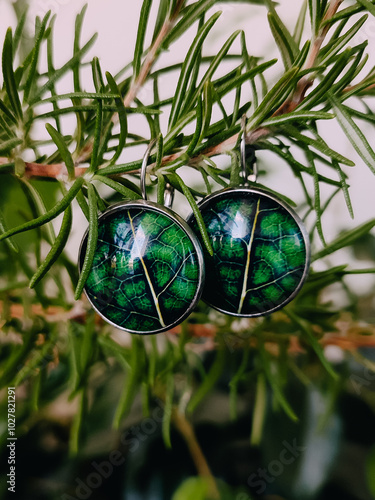 Handmade resin earrings real green leaves encased in a transparent finish at green rosemary branch. Leverback hooks, secure wear, nature-inspired jewelry collection, handcrafted jewellery, accessory photo