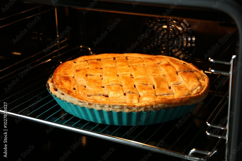 Baking dish with homemade apple pie in oven, closeup Baking dish with homemade apple pie in oven, closeup