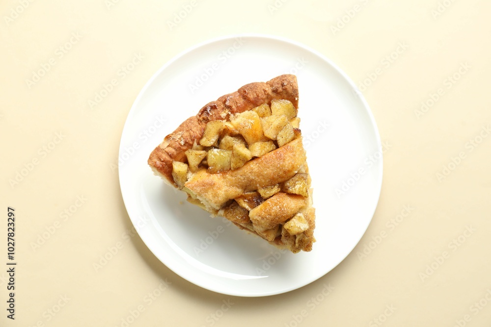 Slice of homemade apple pie on beige background, top view Slice of homemade apple pie on beige background, top view