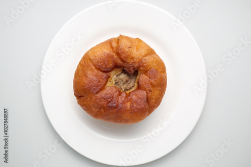 Deep fried meat pie on a white porcelain plate.