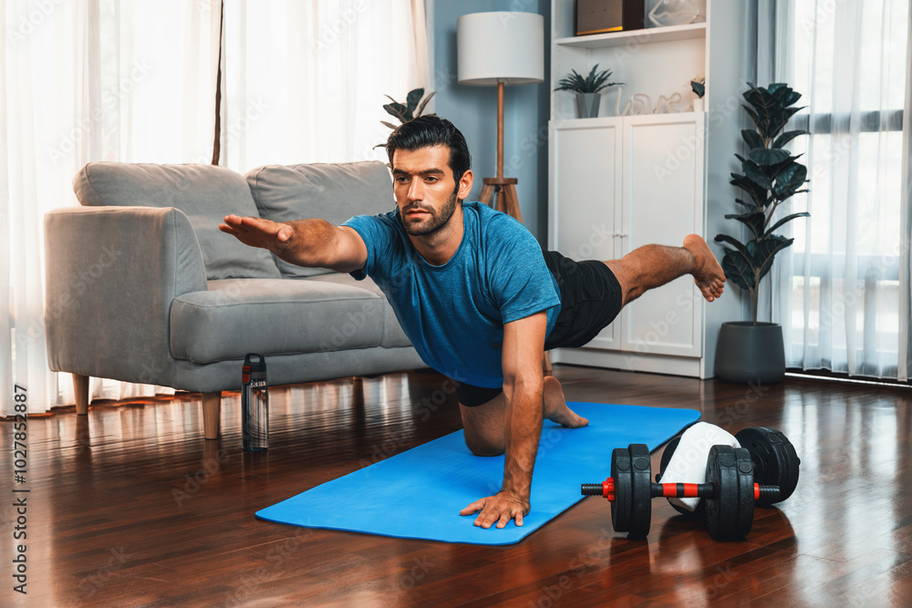 Flexible and dexterity man in sportswear doing yoga position in meditation posture on exercising mat at home. Healthy gaiety home yoga lifestyle with peaceful mind and serenity. Flexible and dexterity man in sportswear doing yoga position in meditation posture on exercising mat at home. Healthy gaiety home yoga lifestyle with peaceful mind and serenity.
