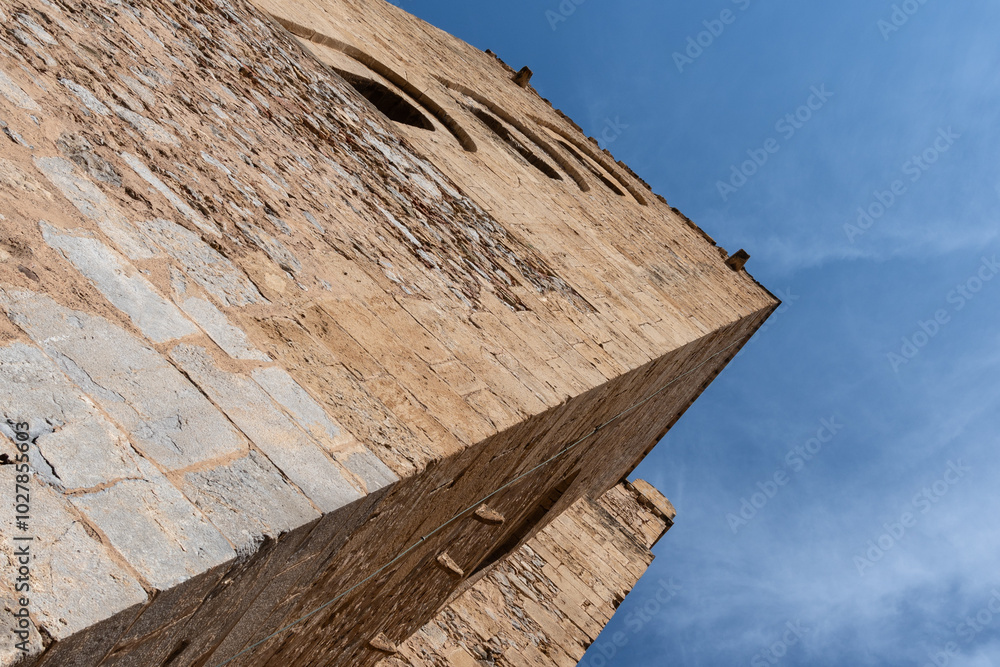 view from below of the ancient towers of the Norman cathedral of Cefalù in Sicily silhouetted majestically against an incredibly blue sky view from below of the ancient towers of the Norman cathedral of Cefalù in Sicily silhouetted majestically against an incredibly blue sky