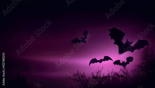 Silhouettes of bats flying across a gradient night sky, transitioning from deep purple to black photo