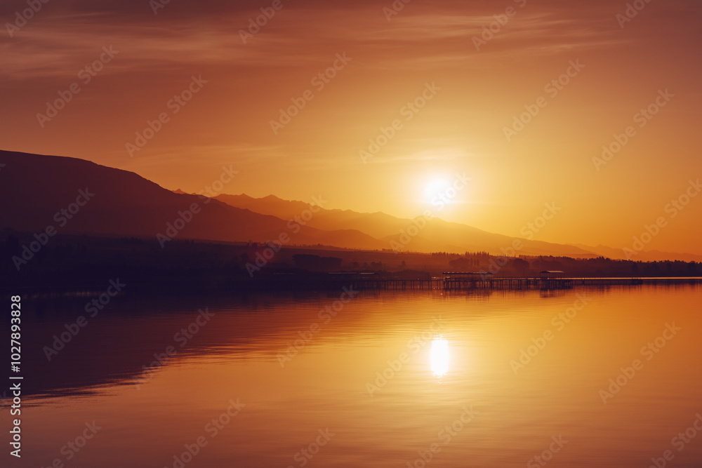 Fototapeta premium Sunset over lake in summer, vibrant dramatic colors