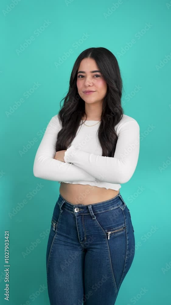 Portrait of smiling latina woman thumbs up in a studio, blue background Portrait of smiling latina woman thumbs up in a studio, blue background
