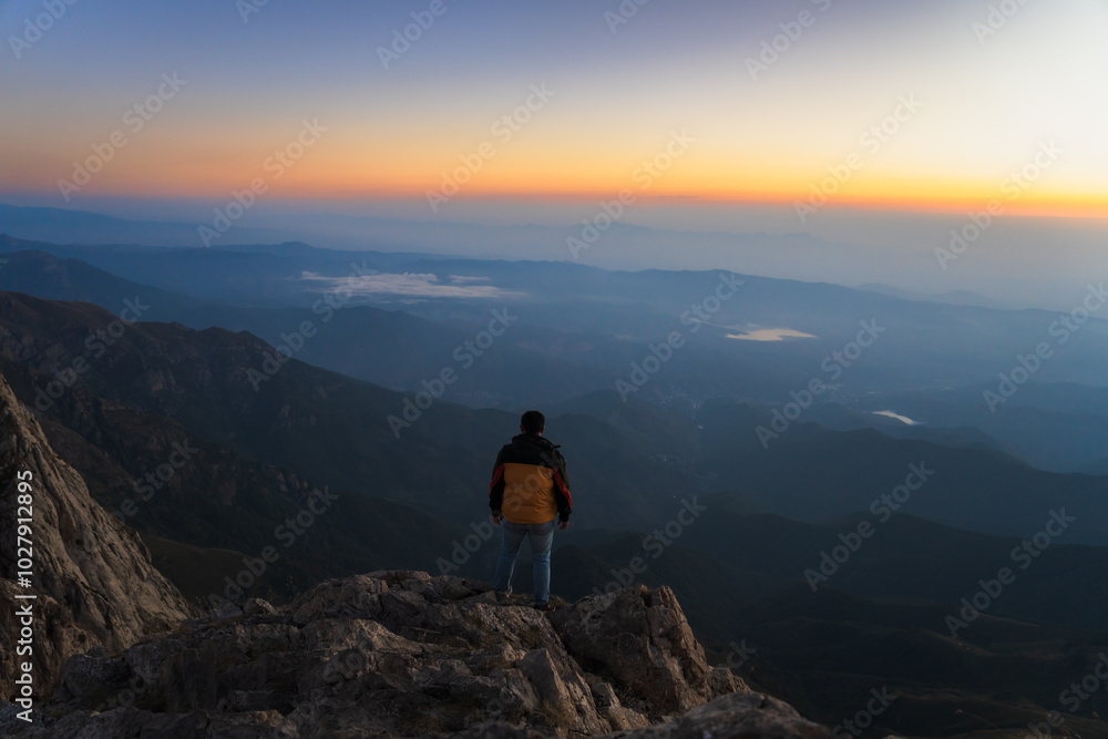 Fototapeta premium A mountaineer on top of a high mountain