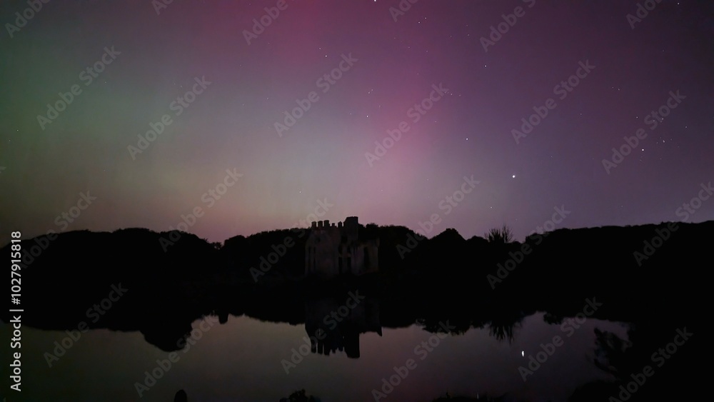 Aurora borealis, northern lights in the sky above Menlo castle, Galway, Ireland, nature background
