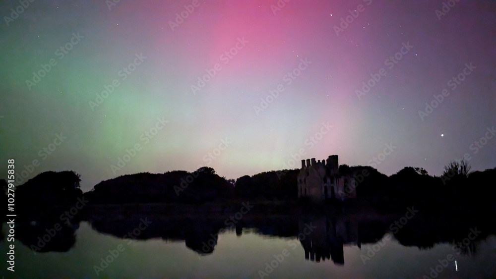 Aurora borealis, northern lights in the sky above Menlo castle, Galway, Ireland, nature background