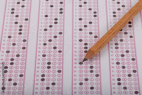 Exam, a hand taking an exam with a pen on an optical reader. Exam, an idea concept. Anxiety about the future, uncertainty. Multiple choice exam. Adults taking an exam. photo