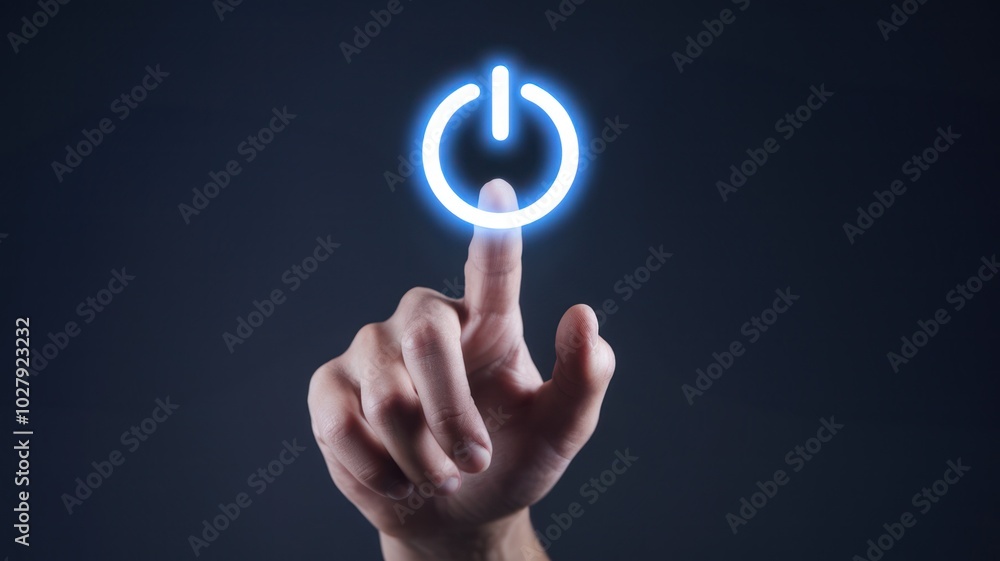Hand pressing glowing power button on dark background, symbolizing technology activation. Hand pressing glowing power button on dark background, symbolizing technology activation.