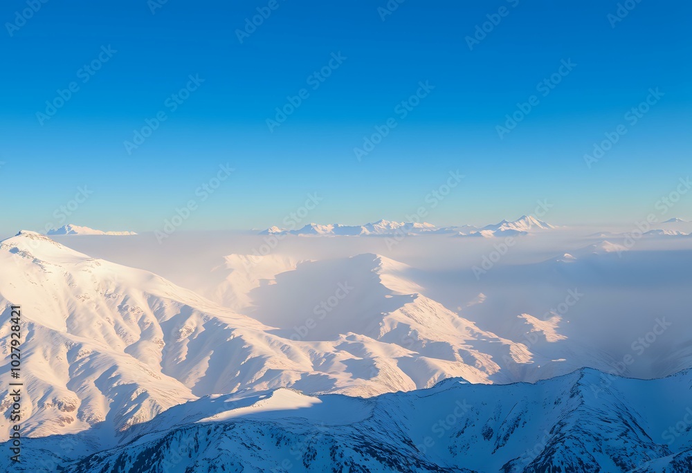 Fototapeta premium Snow-Covered Mountain Range under Clear Blue Sky