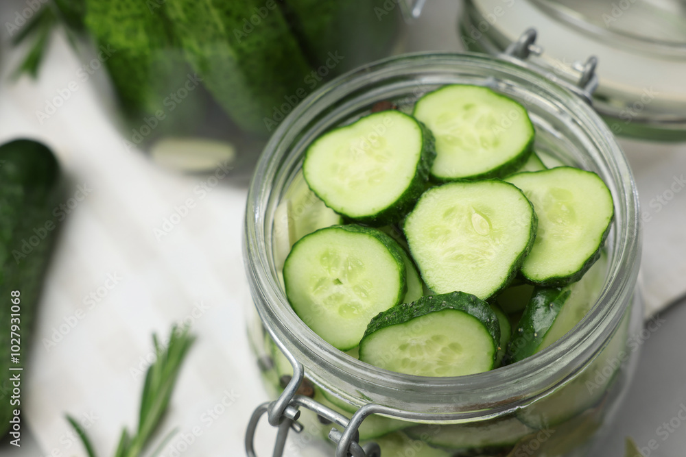Homemade pickles. Fresh cucumbers in jar on table, closeup Homemade pickles. Fresh cucumbers in jar on table, closeup