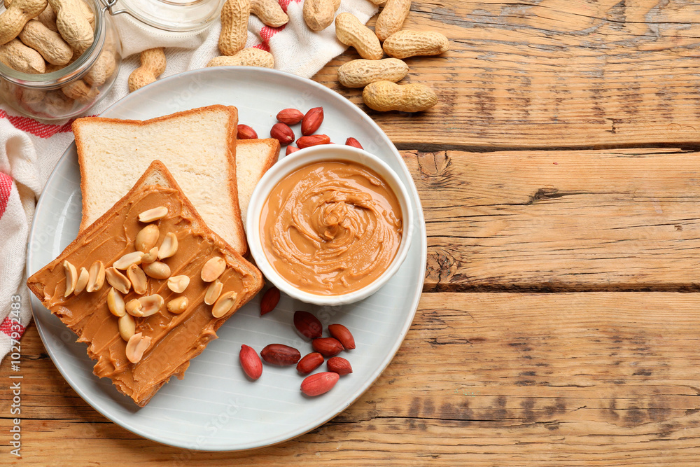 Delicious sandwich with peanut butter and fresh nuts on wooden table, flat lay. Space for text Delicious sandwich with peanut butter and fresh nuts on wooden table, flat lay. Space for text