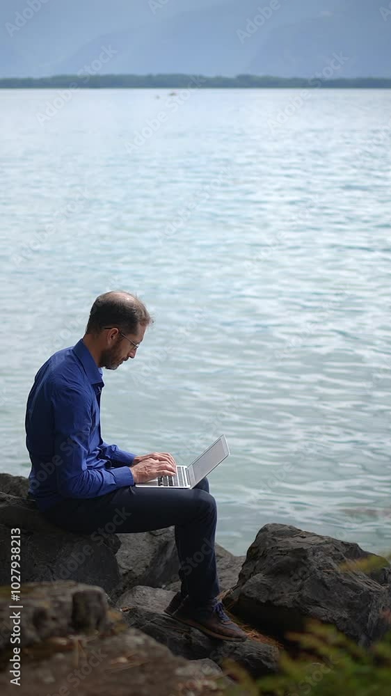 A Digital Nomad Enjoying the Beauty of Working by the Waters Edge in Peaceful Surroundings A Digital Nomad Enjoying the Beauty of Working by the Waters Edge in Peaceful Surroundings