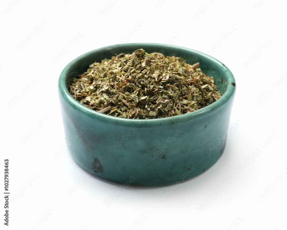 Dried oregano in bowl isolated on white Dried oregano in bowl isolated on white