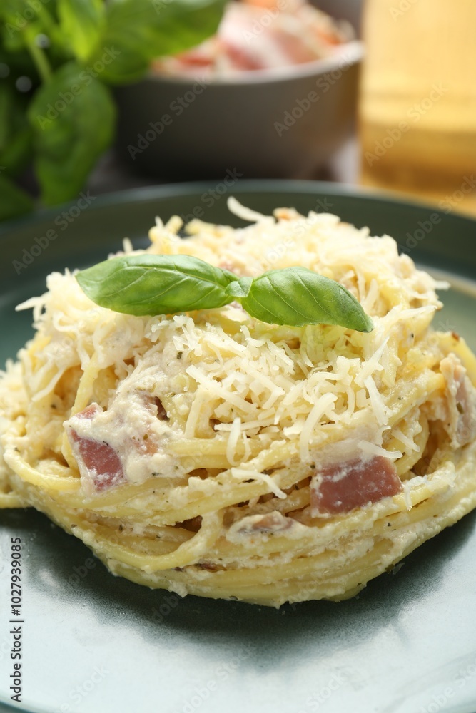 Fototapeta premium Delicious pasta Carbonara with basil on table, closeup