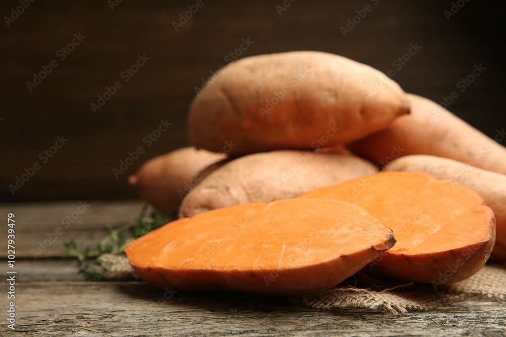 Fresh raw sweet potatoes on wooden table, closeup Fresh raw sweet potatoes on wooden table, closeup
