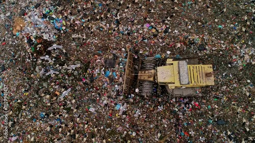 This video shows birds, including seagulls and storks, scavenging in a city landfill while garbage trucks unload waste. Ideal for themes related to ecology and environmental issues.