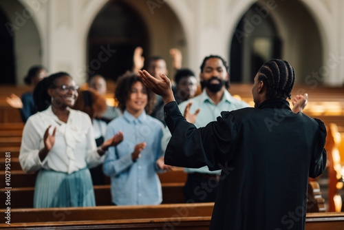 African american preacher leading congregation in prayer