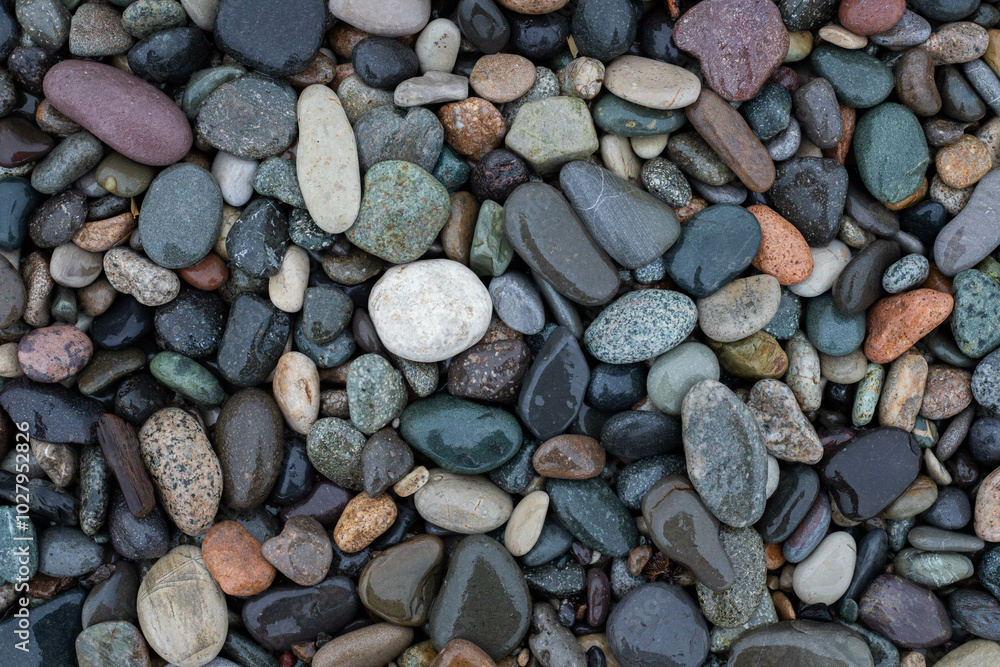 colorful small sea stone pebble background on the sea shore. Multicolored abstract beach nature wallpaper colorful small sea stone pebble background on the sea shore. Multicolored abstract beach nature wallpaper