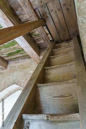 An old antique wooden staircase. An external staircase for the entrance to the bell tower of the old church.