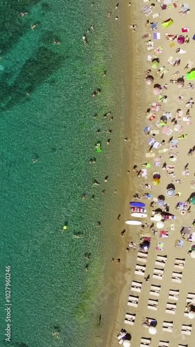 Aerial vew of sandy beach and green blue sea in the middle of the summer