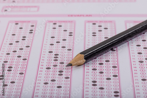 Exam, a hand taking an exam with a pen on an optical reader. Exam, an idea concept. Anxiety about the future, uncertainty. Multiple choice exam. Adults taking an exam. photo