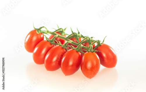 Fresh red cherry tomatoes on a branch on a white background