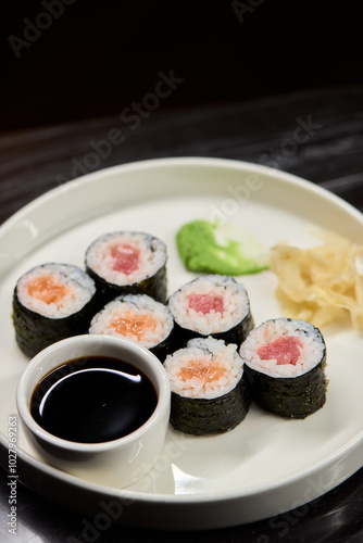 A Beautiful Plate Filled with Delicious Sushi Rolls Accompanied by Soy Sauce for Dipping