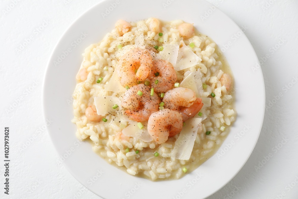 Delicious risotto with shrimps and cheese on white table, top view Delicious risotto with shrimps and cheese on white table, top view