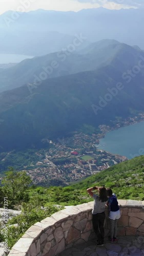 Tourists kids stands on the observation deck of the Bay of Kotor
