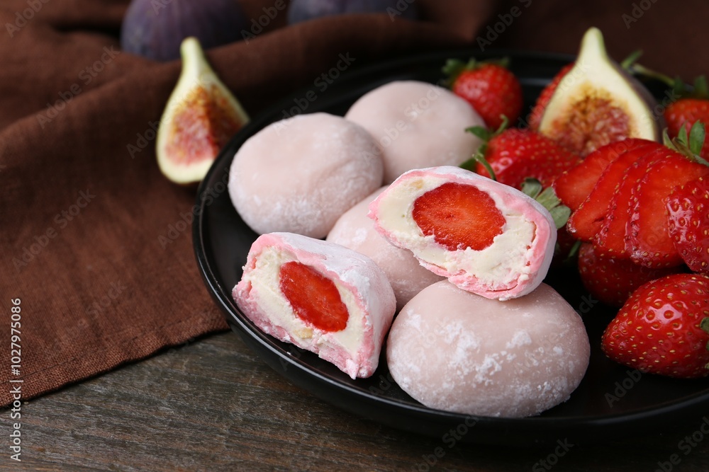 Delicious mochi with strawberries and figs on wooden table, closeup Delicious mochi with strawberries and figs on wooden table, closeup
