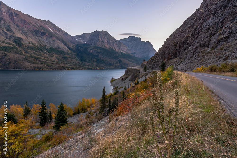 Beautiful view of the scenic Glacier National Park landscape in twilight. St. Mary Lake and Going-to-the-sun road in autumn season Beautiful view of the scenic Glacier National Park landscape in twilight. St. Mary Lake and Going-to-the-sun road in autumn season